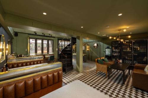 a restaurant with a bar with chairs and a table at Shamrock Chiangmai Hotel-Adult Only in Chiang Mai