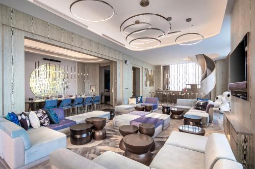 a lobby with couches and tables and a bar at W Chengdu in Chengdu