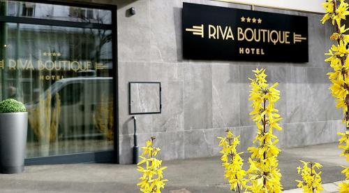 a building with yellow flowers in front of it at RIVA Boutique Hotel in Szeged