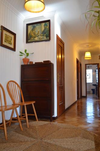 a living room with a table and a chair and a table at Casa Aurora in Teo