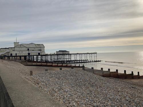 a pier on a beach next to the ocean at 50 meters from Beach. in Bognor Regis