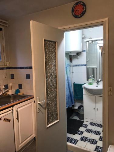 a small bathroom with a sink and a toilet at Chez Bibi in Neuilly-sur-Marne
