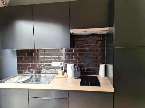 a kitchen with a sink and a counter top at Bulle des Fagnes in Philippeville