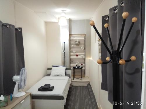 a small room with a small bed in it at GEORGIA APARTMENT ATHENS AIRPORT in Artemida
