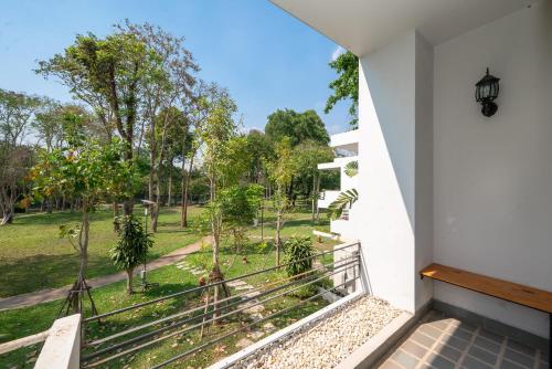 a balcony with a view of a park at Comsaed River Kwai Resort in Kanchanaburi