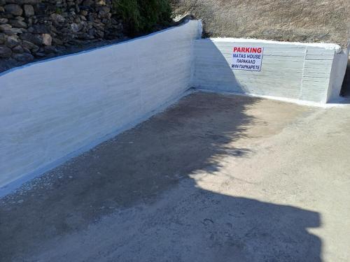 a retaining wall with a warning sign next to it at MATAS HOUSE in Tiros