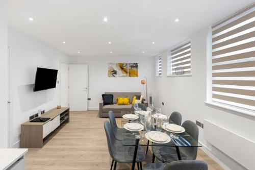 a dining room and living room with a table and chairs at Luxurious 2 BR - Apartment - Sleeps 6 in London