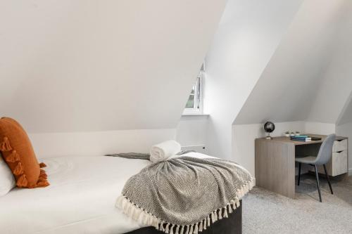 a white bedroom with a bed and a desk at Luxurious 2 BR - Apartment - Sleeps 6 in London