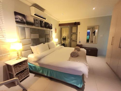 a bedroom with a large bed in a room at Clanwilliam Oasis - Naturism, Boating, Hiking & more in Clanwilliam
