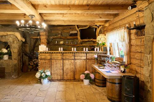 a bar in a room with wooden walls at Hotel Jaśmin in Owińska