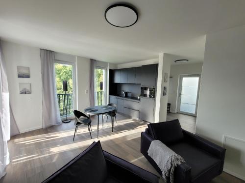 a living room with a couch and a table at Egge Resort 7d Viaduktblick, Balkon in Altenbeken