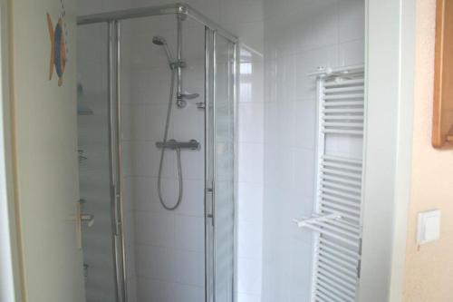 a bathroom with a shower with a glass door at Heggerank 80* in Nieuwvliet