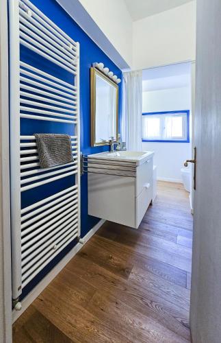 a bathroom with a sink and a blue wall at Casa Margherita in Ancona