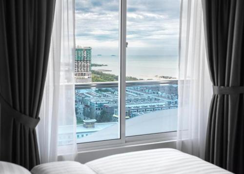 une chambre avec une fenêtre avec vue sur une ville dans l'établissement The Wave Heritage Residence Malacca-Near to Jonker Walk, à Malacca