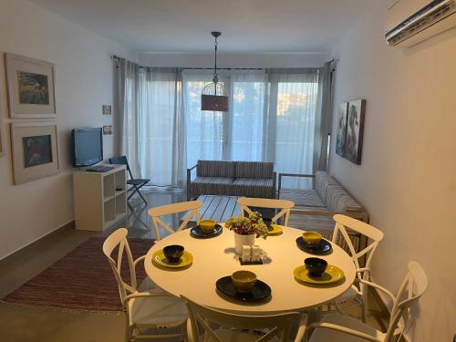 a living room with a table and chairs in a room at Almaza Bay, 2 bd ground floor (Prime location) in Marsa Matruh