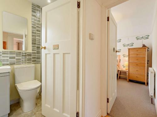 a bathroom with a toilet and a sink at 4 Bed in Aberporth 93783 in Aberporth