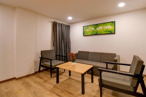 a living room with a couch and a table at Super Townhouse City Centre 2 Downtown - Managed by Company in Kolkata