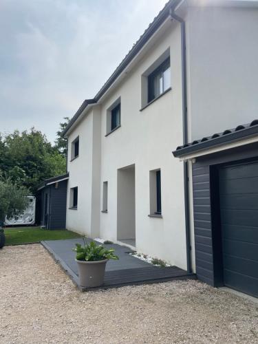 a white house with a garage at Grande villa avec piscine et spa in Longages