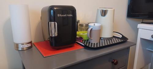 a counter with a coffee maker on top of a counter at Aylesbury Lovely Double and Single Bedroom with Guest only Bathroom in Buckinghamshire