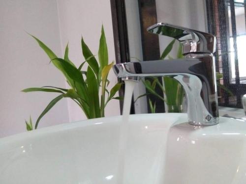a sink with a faucet in a bathroom at Eecfc Home Stay(VHS) in Phumĭ Ta Rós