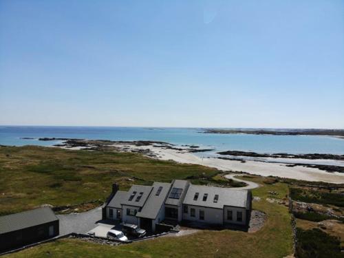 an aerial view of a house next to the ocean at Doleen House in Ballyconneely