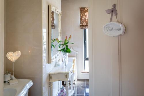 a bathroom with a sink and a mirror at Doleen House in Ballyconneely