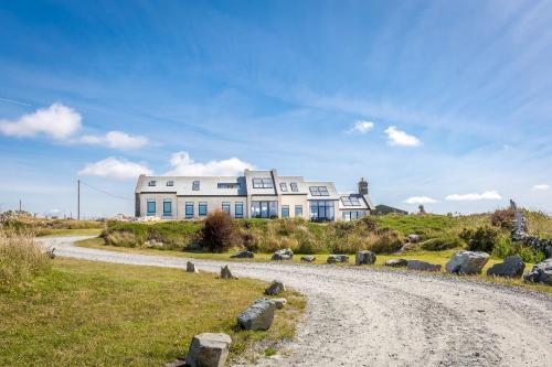 a house on a hill with a gravel road at Doleen House in Ballyconneely