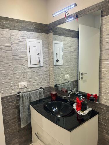a bathroom with a black sink and a mirror at Casa vacanze da Mely in Marsala