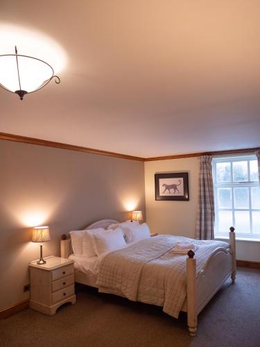 a bedroom with a large bed and a window at The Vestry in Chichester