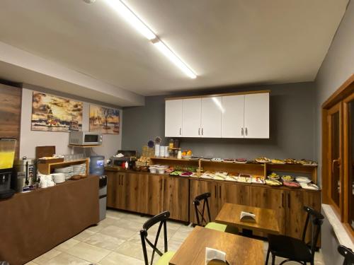 a kitchen with a counter and a table and chairs at Zeyn Otel Istanbul in Istanbul