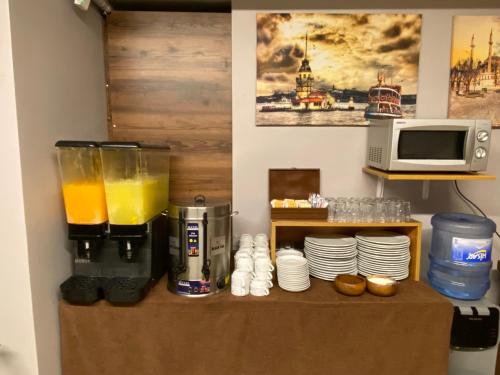a kitchen with a blender with orange juice on a table at Zeyn Otel Istanbul in Istanbul