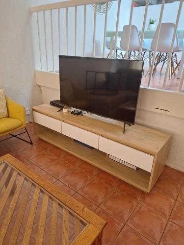 a living room with a flat screen tv on a table at San Lameer Villa 3103 in Southbroom