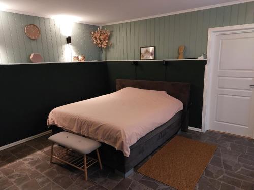 a bedroom with a bed and a chair in it at "Huset Alcamaro" 