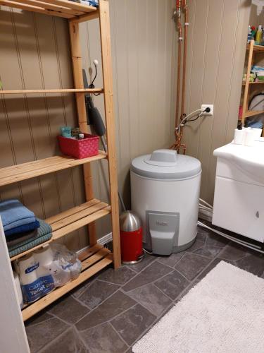a bathroom with a toilet and a sink at "Huset Alcamaro" in Haugland