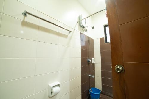 a bathroom with a shower with a toilet at Casañas Suites in Puerto Princesa City