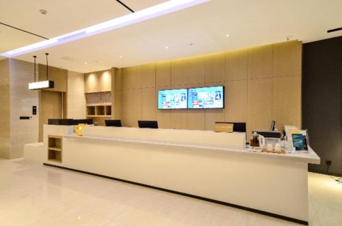 a lobby of a pharmacy with a reception counter at City Comfort Inn Yichang Sanxia Airport in Ku-lao-pei