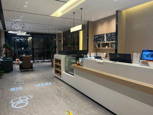 a lobby of a store with a counter and chairs at City Comfort Inn Nanyang Nanshi Hospital in Nanyang