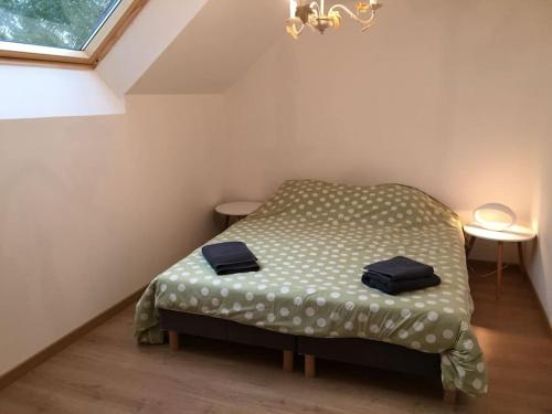 a small bedroom with a bed in a attic at Maison de campagne in Le Baizil