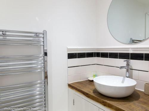 een badkamer met een witte wastafel en een spiegel bij Central seaside home with peaceful patio in Brighton & Hove