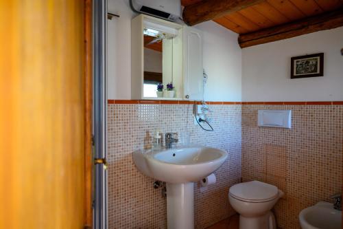 a bathroom with a sink and a toilet at Mirose's holiday home 39 in Castelbuono