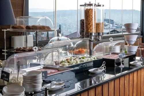 a buffet line with food on display in a restaurant at Urban Boutique Hotel in Tbilisi City