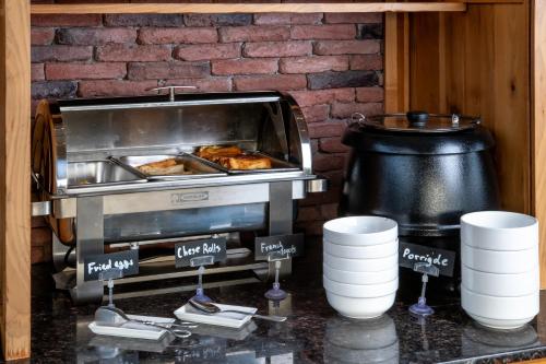 a kitchen with a grill with some food in it at Urban Boutique Hotel in Tbilisi City
