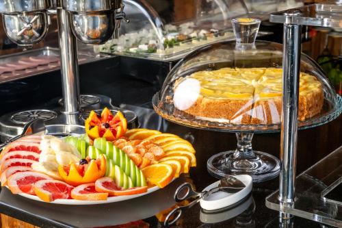 a plate of food with fruit on a table at Urban Boutique Hotel in Tbilisi City