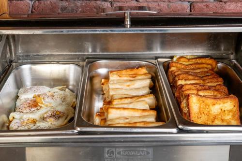 four trays of pastries and bread in a appliance at Urban Boutique Hotel in Tbilisi City