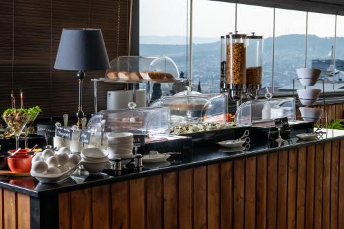 a buffet with food on a counter in a restaurant at Urban Boutique Hotel in Tbilisi City
