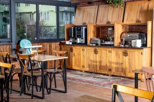 a restaurant with wooden cabinets and a table and chairs at Urban Boutique Hotel in Tbilisi City
