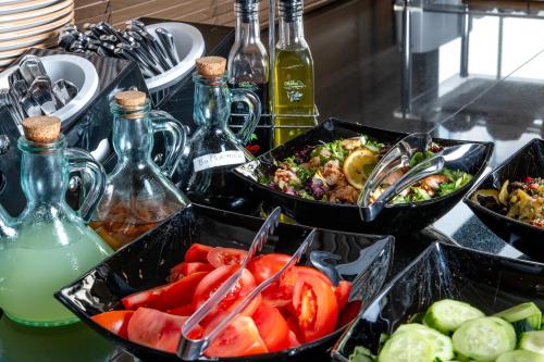 two trays of food on a counter with bottles of drinks at Urban Boutique Hotel in Tbilisi City