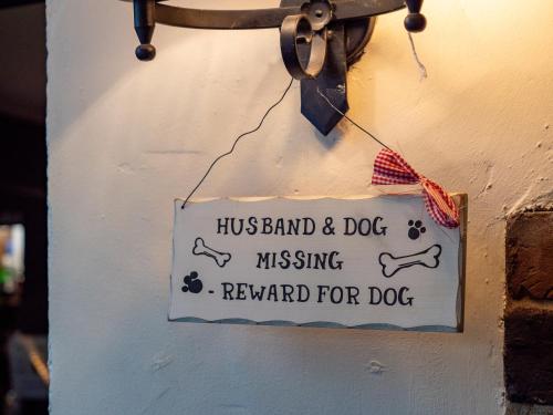a sign on a wall that reads hunk and dog missing reward for dog at The Jolly Drover in Liss