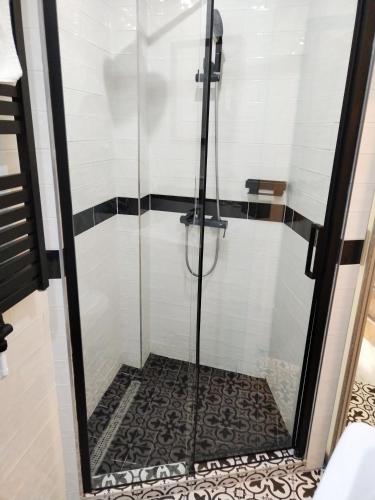 a shower with a glass door in a bathroom at Hotel Na Baste in Jablonec nad Nisou