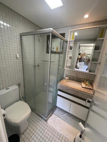 a bathroom with a shower and a toilet and a sink at EKOARA BEIRA MAR 127 in Porto De Galinhas